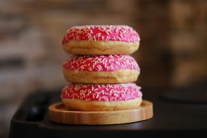 Donuts with delicious strawberry flavoured cream and sprinkles