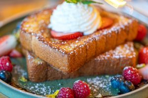 french toasted bread with lots of berries and creams